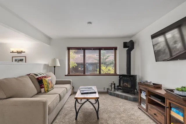 a livingroom with workspace couch and a window