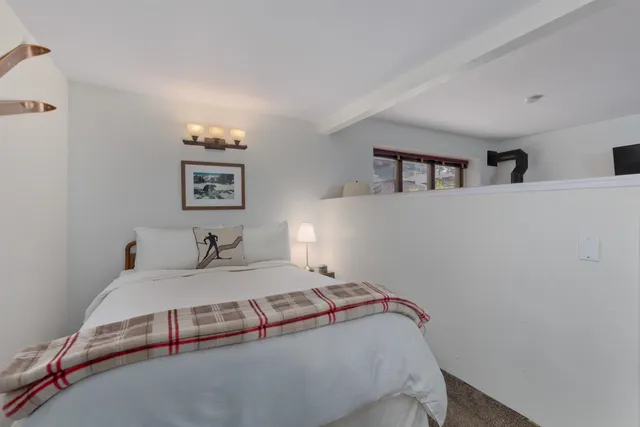 a bedroom with a bed and two night stand