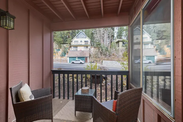 a view of a porch with furniture and wooden floor