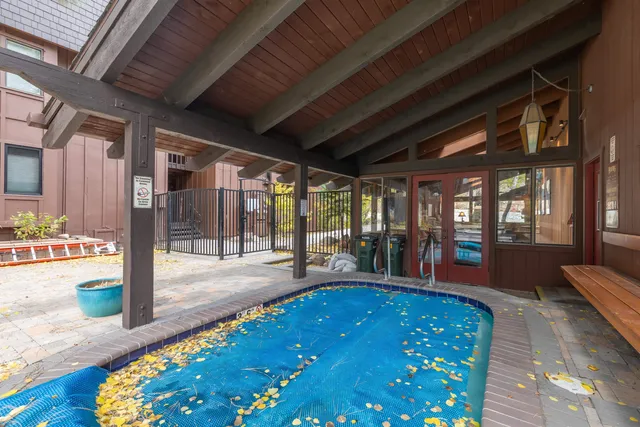 a swimming pool with large glass windows and painted walls