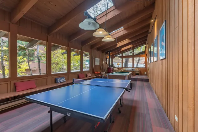 a dining room with wooden floor and large window