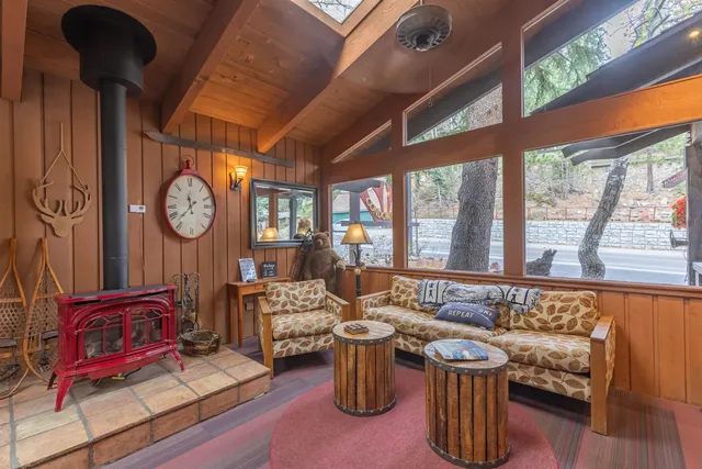 a living room with furniture a clock and a large window
