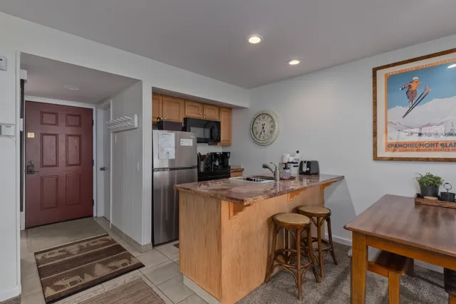 a view of a workspace with furniture and bathroom