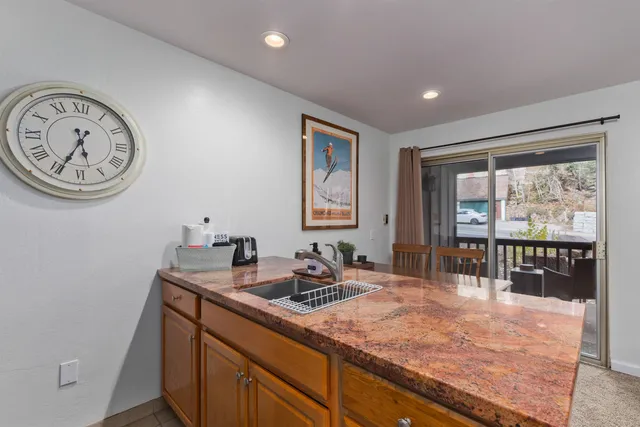 a bathroom with a granite countertop sink a large mirror and a window