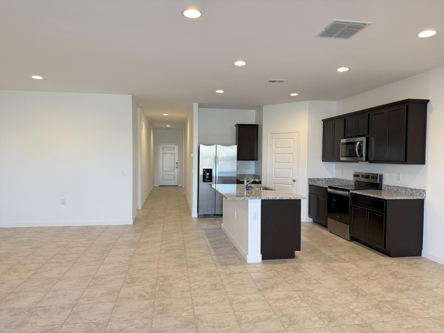 1840 West Spaulding Avenue Apache Junction, AZ 85120 - Photo 35 of 53 a large kitchen with a center island and stainless steel appliances