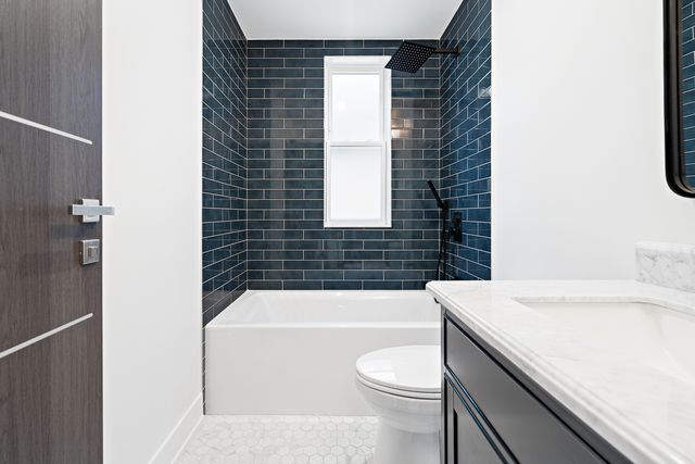 a bathroom with a sink a toilet and bathtub