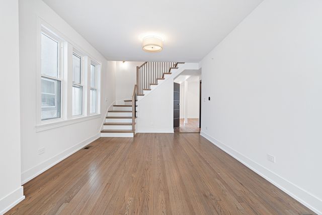 a view of an entryway with wooden floor
