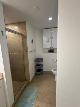 a bathroom with a shower and a sink