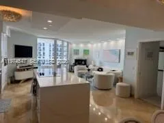a large living room with a couch and a flat screen tv
