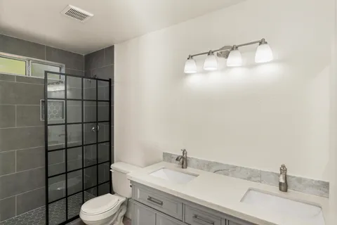 a bathroom with a sink toilet and shower