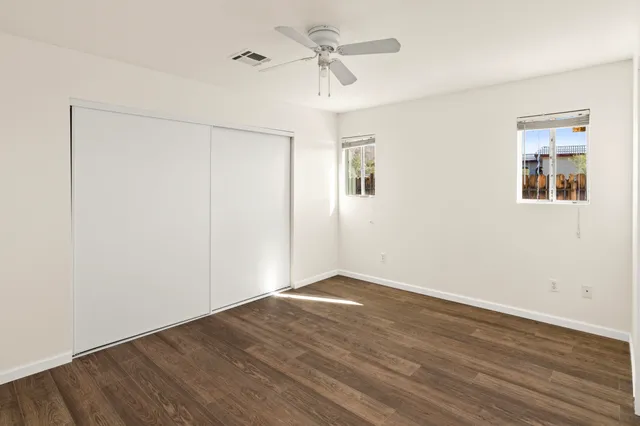 a view of an empty room with wooden floor