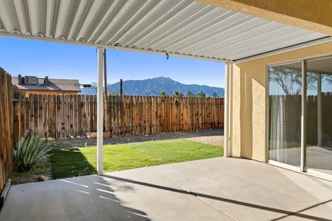 a view of a backyard with wooden fence