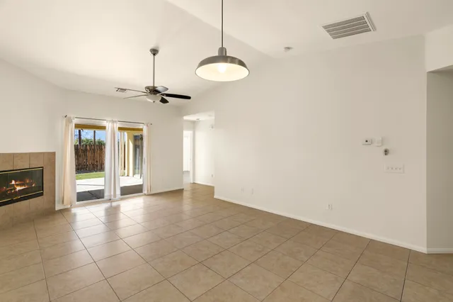 a view of an empty room with a fireplace