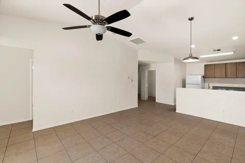 a view of a kitchen with a sink and a refrigerator