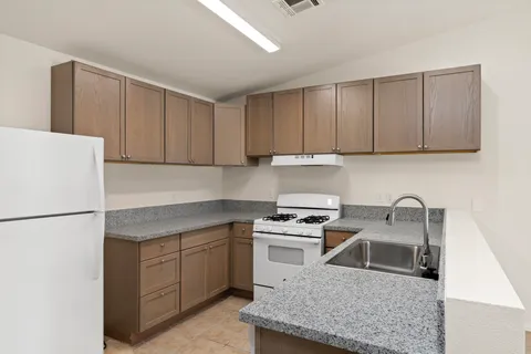 a kitchen with a sink a stove and refrigerator