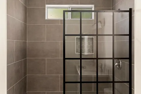 a bathroom with a glass shower door