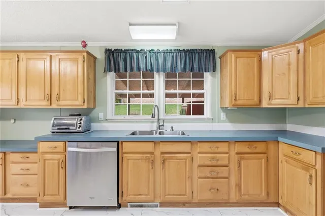 a kitchen with granite countertop cabinets and window
