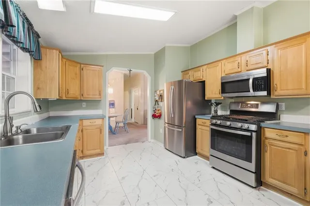 a kitchen with stainless steel appliances granite countertop a refrigerator stove microwave and sink