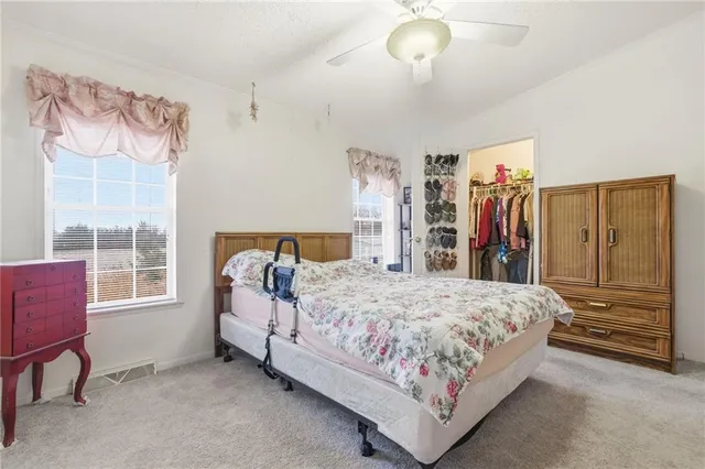 a bedroom with a large bed and a chandelier