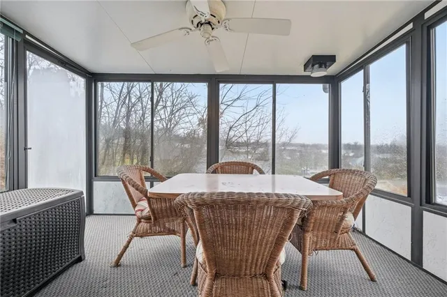 a dining room with furniture a chandelier and wooden floor