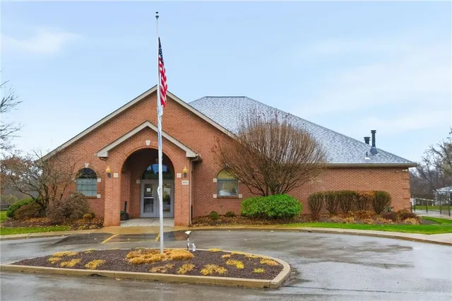 an outdoor space with pool and trees