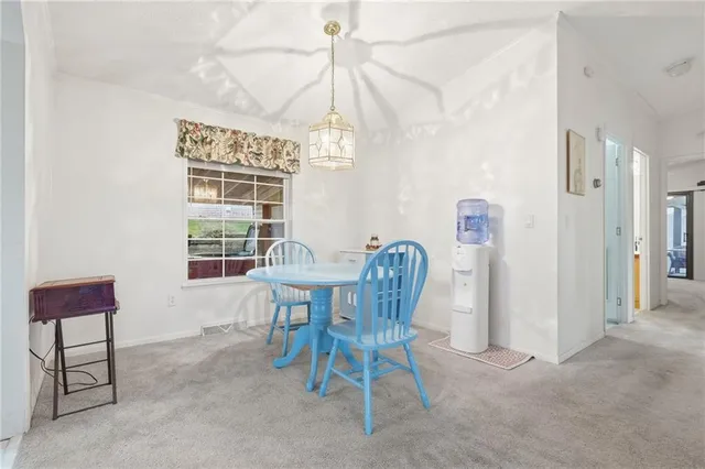a view of a room with furniture and a window