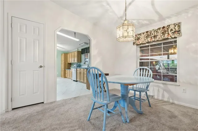 a view of a dining room with furniture and window