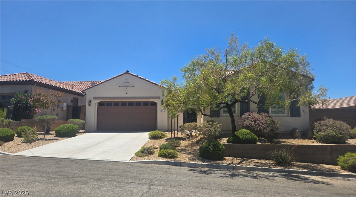 2567 Dirleton Place Henderson, NV 89044 - Photo 1 of 67 A desert-friendly landscape surrounds this charming stucco residence with a concrete driveway leading to the garage.