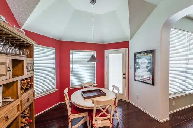 a dining room with furniture and window