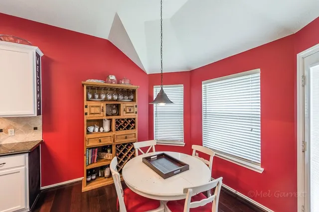 a dining room with furniture and wooden floor