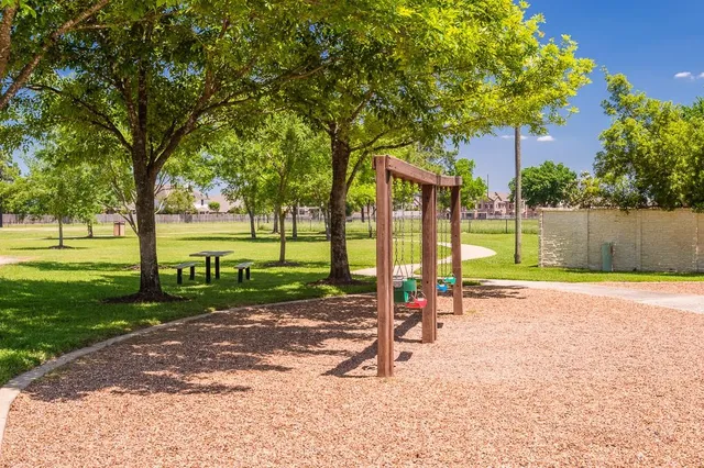 a view of a park with swings and slides