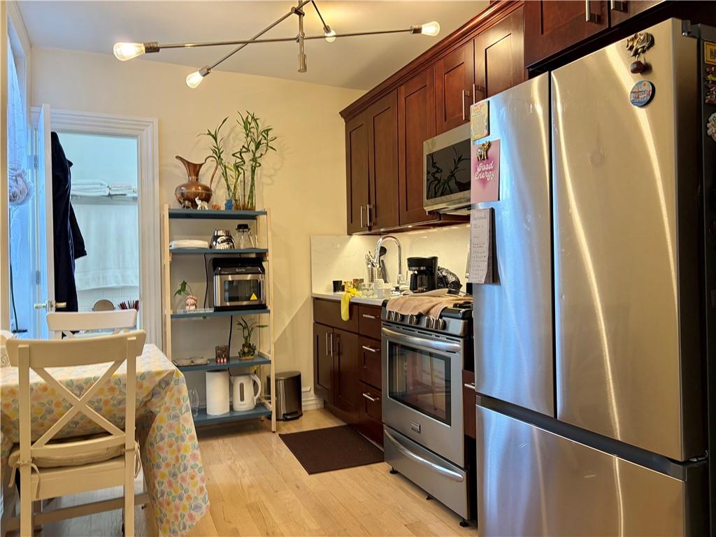 1077 Bay Ridge Parkway Brooklyn, NY 11228 - Photo 2 of 16 a kitchen with stainless steel appliances granite countertop a refrigerator stove and microwave