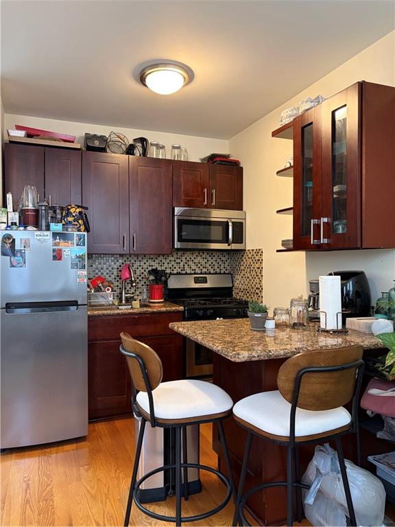 1077 Bay Ridge Parkway Brooklyn, NY 11228 - Photo 6 of 16 a kitchen with stainless steel appliances granite countertop a stove top oven a sink dishwasher and cabinets with wooden floor