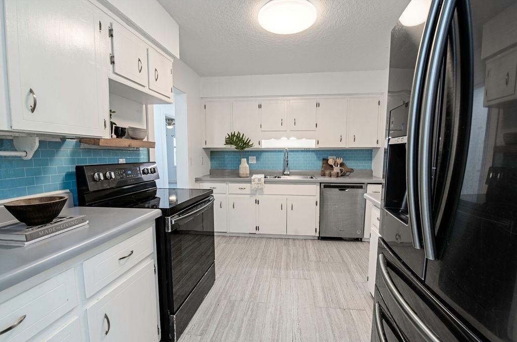 149 Pompano Road St. Augustine, FL 32086 - Photo 11 of 35 a kitchen with a sink stove and refrigerator