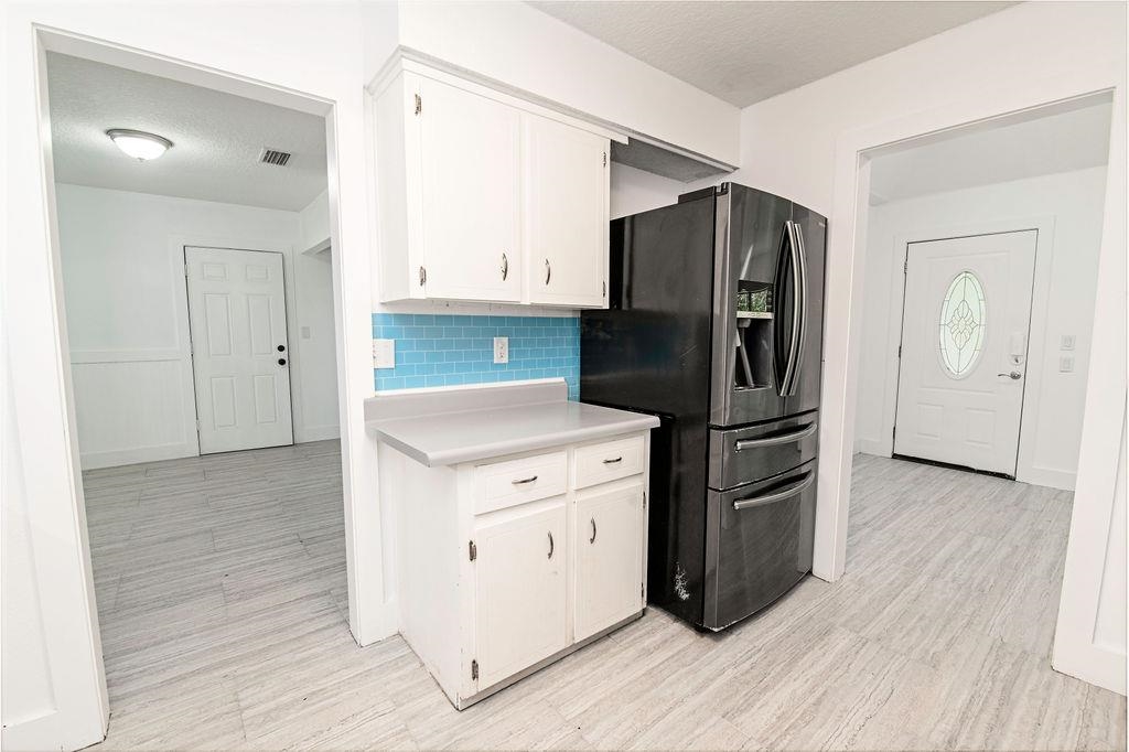 149 Pompano Road St. Augustine, FL 32086 - Photo 13 of 35 a kitchen with a refrigerator cabinet and a sink