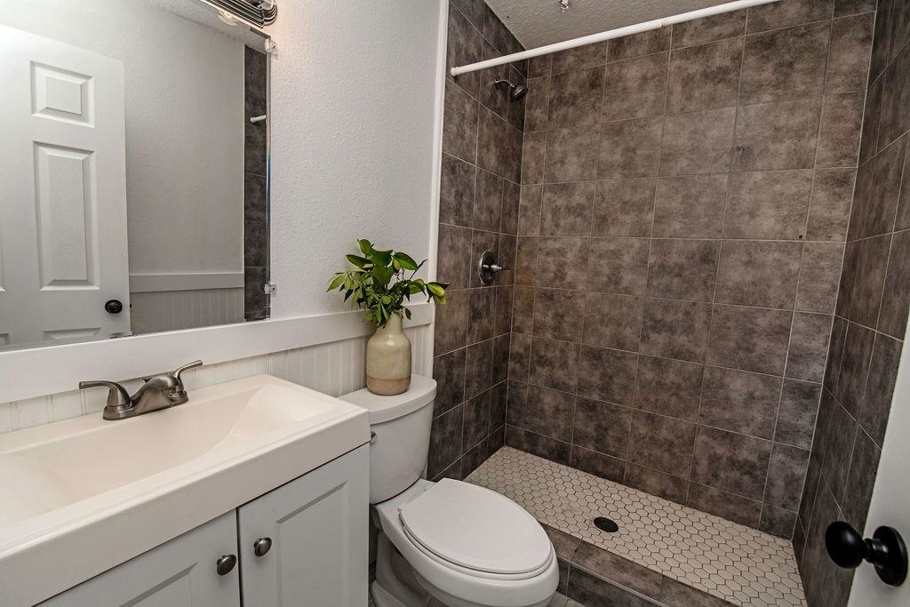 149 Pompano Road St. Augustine, FL 32086 - Photo 19 of 35 a bathroom with a sink a toilet a mirror and shower