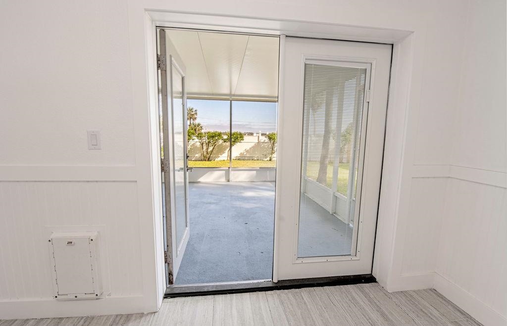 149 Pompano Road St. Augustine, FL 32086 - Photo 27 of 35 a view of an empty room with wooden floor and a window