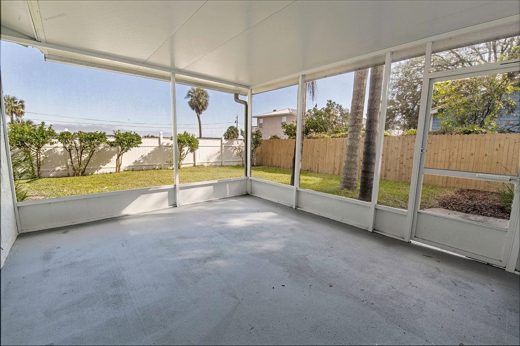149 Pompano Road St. Augustine, FL 32086 - Photo 28 of 35 a view of an empty room with a floor to ceiling window and an outdoor view