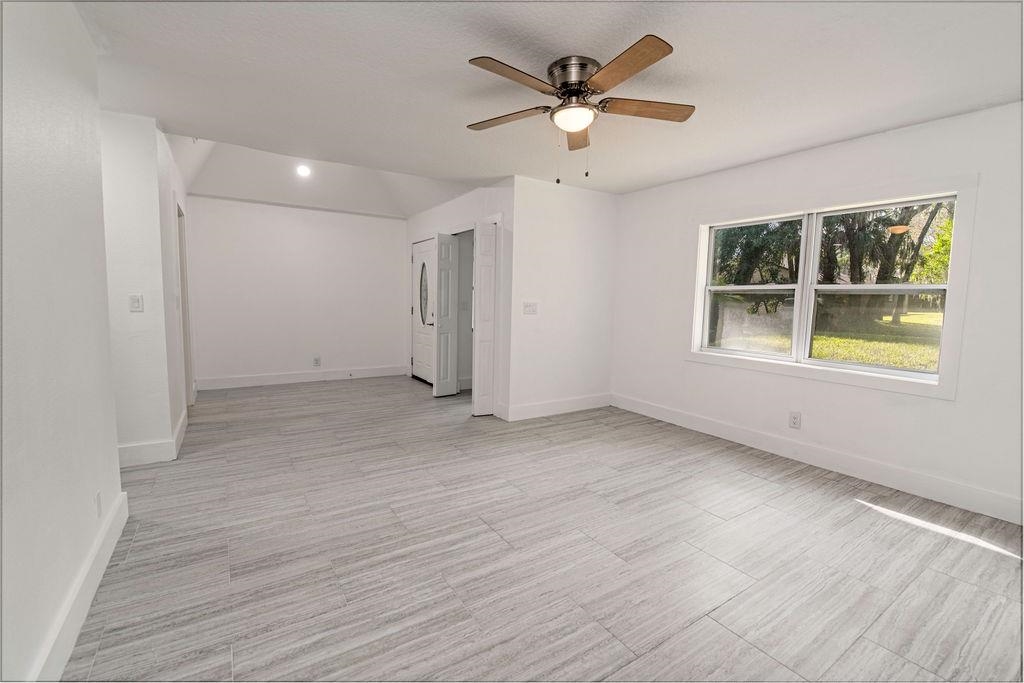 149 Pompano Road St. Augustine, FL 32086 - Photo 8 of 35 an empty room with wooden floor and windows