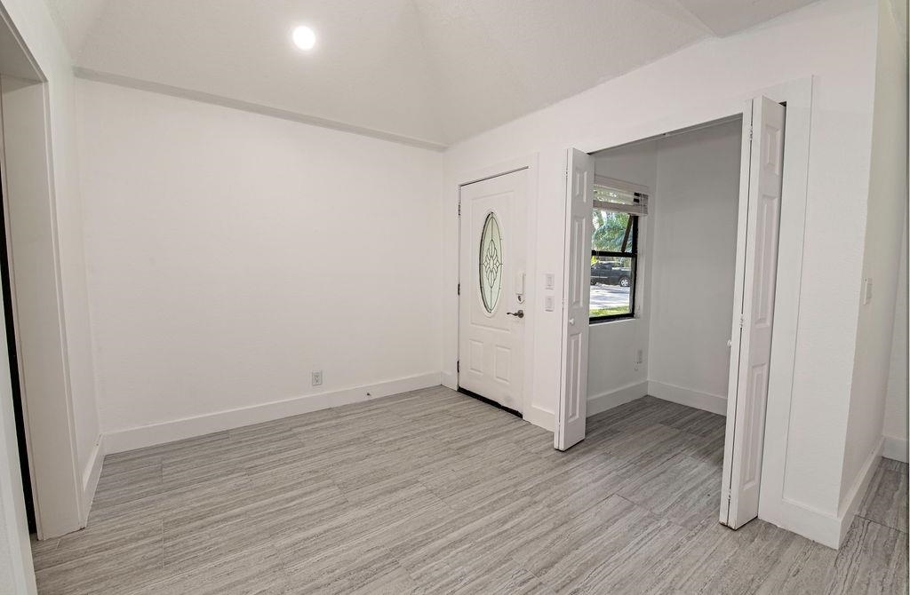 149 Pompano Road St. Augustine, FL 32086 - Photo 9 of 35 an empty room with wooden floor and entrance