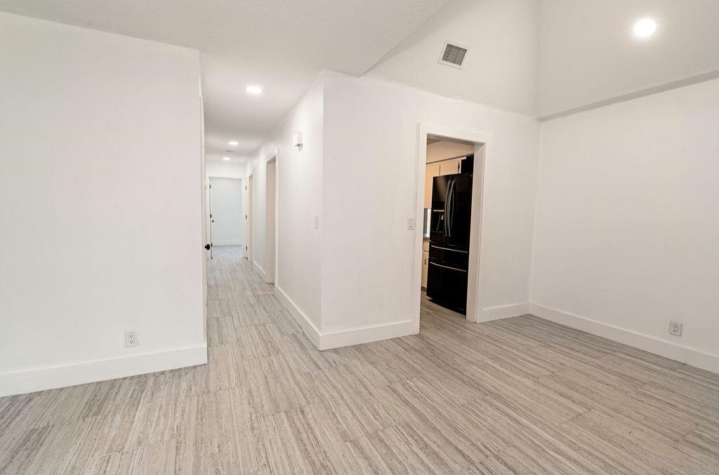149 Pompano Road St. Augustine, FL 32086 - Photo 10 of 35 wooden floor in an empty room with a gallery