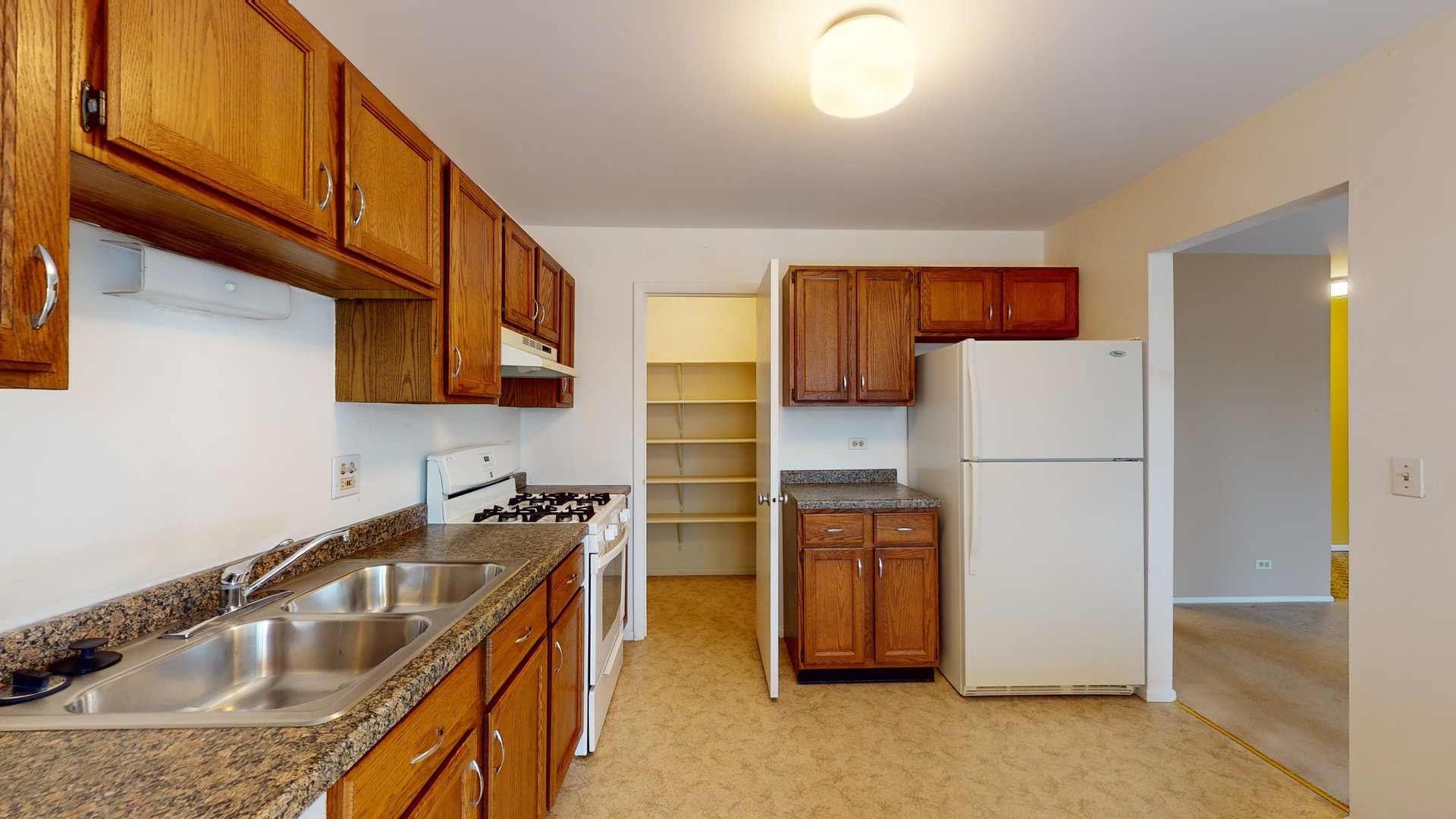 4730 Calvert Drive, Unit B2 Rolling Meadows, IL 60008 - Photo 8 of 20 a kitchen with stainless steel appliances granite countertop a sink a refrigerator a stove a washer and dryer