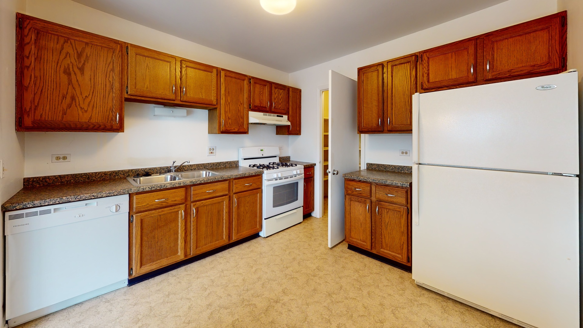 4730 Calvert Drive, Unit B2 Rolling Meadows, IL 60008 - Photo 9 of 20 a kitchen with stainless steel appliances granite countertop a refrigerator a sink dishwasher a stove with wooden cabinets