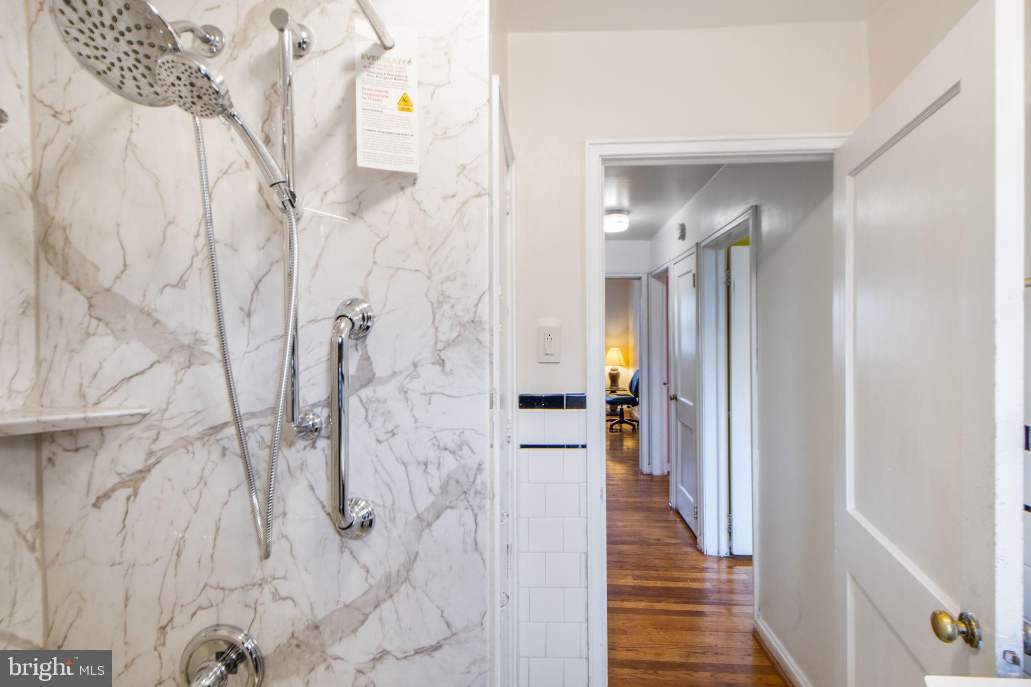 1903 Heathfield Road Baltimore, MD 21239 - Photo 22 of 30 a view of a hallway with wooden floor and staircase