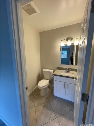 a bathroom with a sink a toilet and mirror