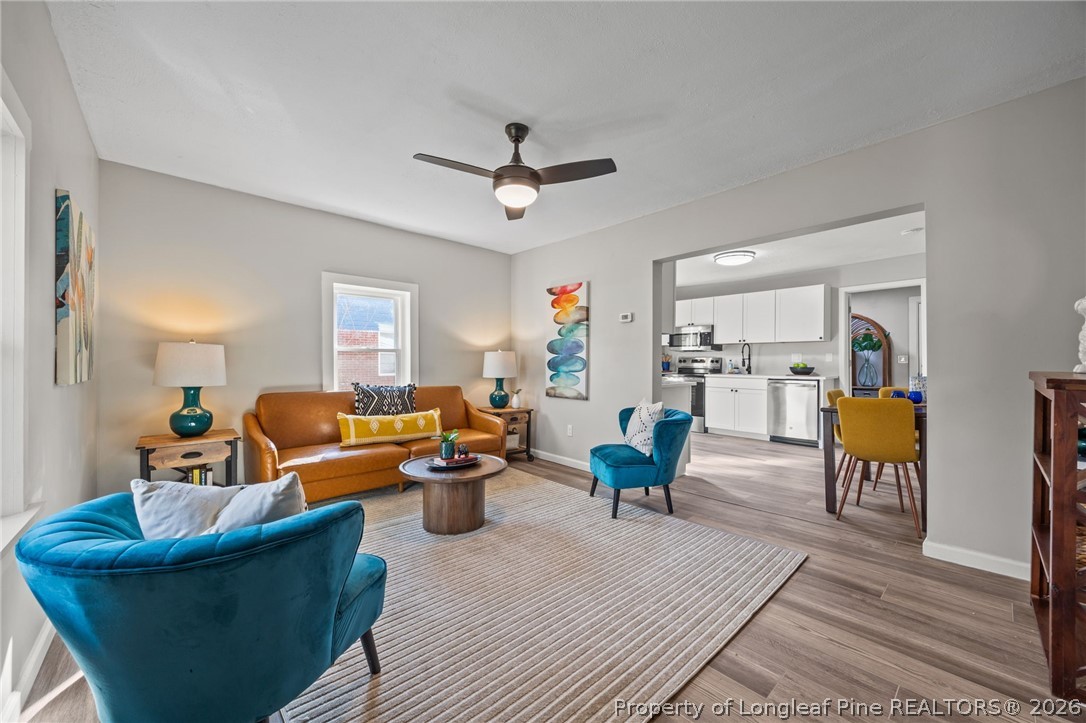 625 Eva Circle Spring Lake, NC 28390 - Photo 7 of 28 a living room with furniture kitchen view and a wooden floor