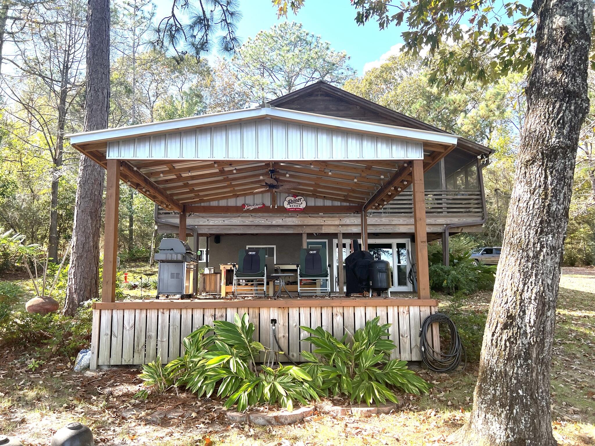 914 Spring Lake Road DeFuniak Springs, FL 32433 - Photo 40 of 78 a view of a house with backyard and sitting area