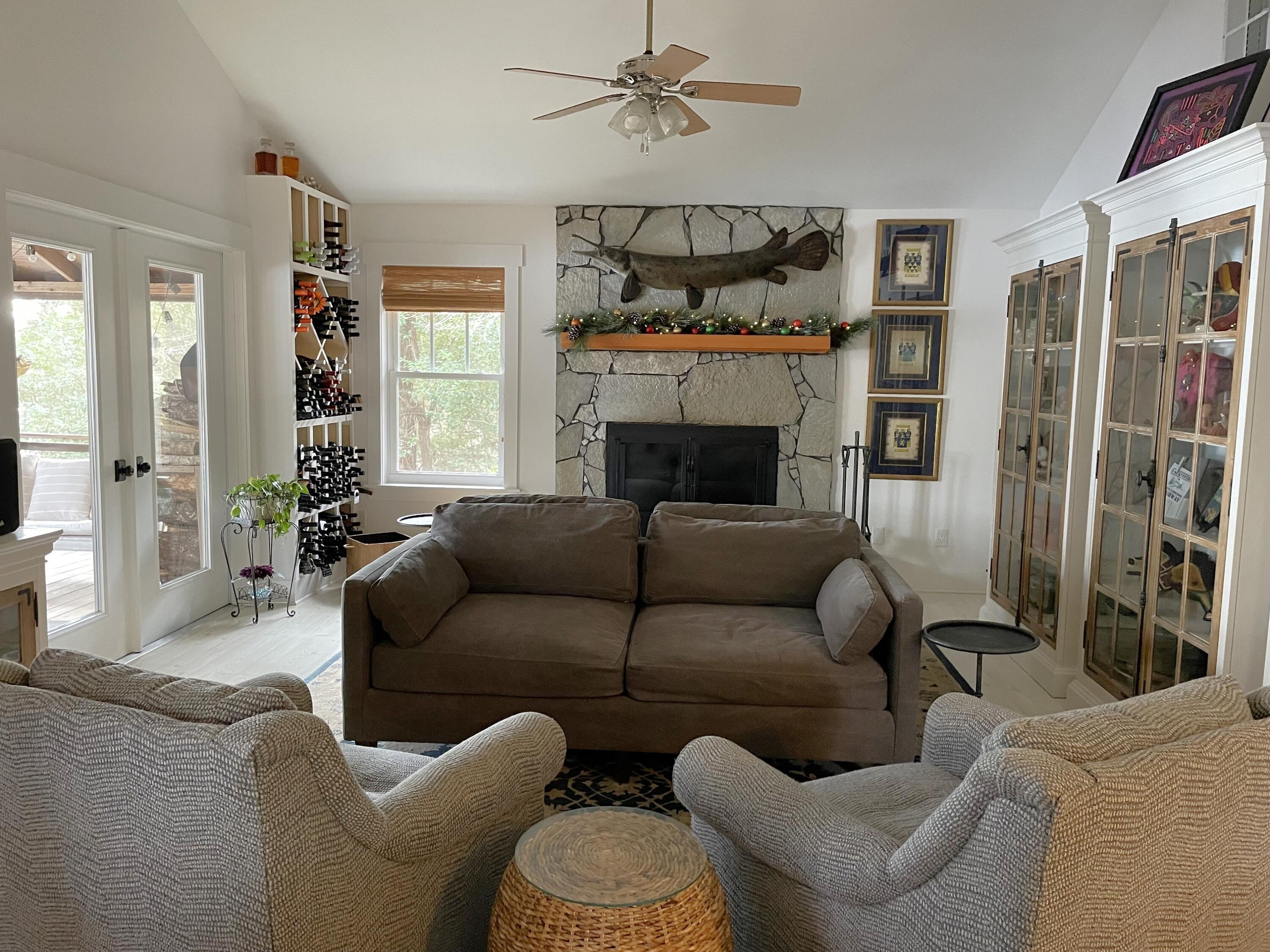 914 Spring Lake Road DeFuniak Springs, FL 32433 - Photo 7 of 78 a living room with furniture a fireplace and a chandelier