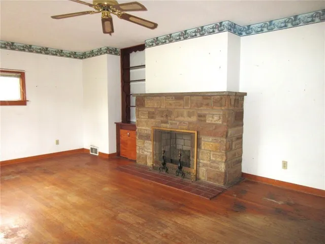 a view of a livingroom with a fireplace and window