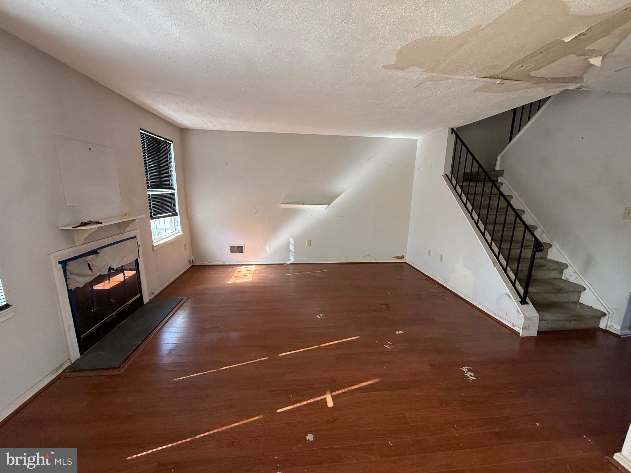 32 River Bank Drive Roebling, NJ 08554 - Photo 2 of 15 a view of an empty room with wooden floor and stairs